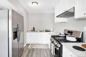 Indio apartment for rent - A modern kitchen with a stainless steel refrigerator and a stove top oven.