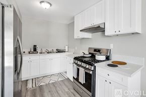 Indio apartment for rent - A kitchen with white cabinets and a stainless steel refrigerator.
