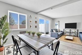 Indio apartment for rent - A modern dining room with a wooden table and chairs.