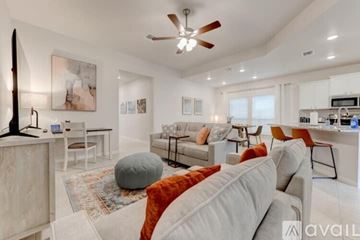 Temple house for rent - A living room with a grey couch and a rug.