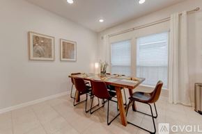 Temple house for rent - A dining room with a table set for four.