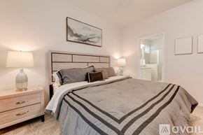 Temple house for rent - A bedroom with a large bed and a nightstand with a lamp.