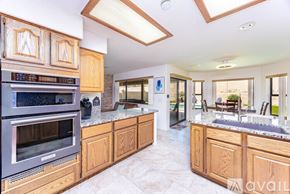Lake Havasu City house for rent - A modern kitchen with wooden cabinets and a stainless steel oven.