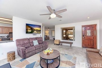 Lake Havasu City house for rent - A living room with a purple couch and a painting on the wall.