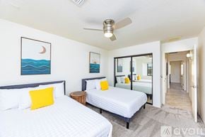 Lake Havasu City house for rent - A bedroom with two beds and a ceiling fan.