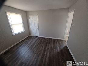 Saint Ann house for rent - A room with a wooden floor and two doors.