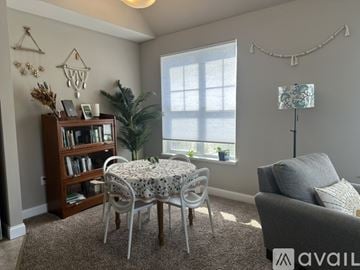 Hartland apartment for rent - A living room with a dining table and chairs, a bookshelf, and a couch.