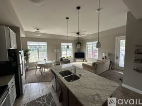 Hartland apartment for rent - A kitchen with granite countertops and a dining area with a table and chairs.