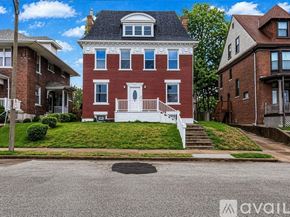 St. Louis house for rent - A living room with a fireplace and wood flooring.
