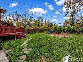 St. Louis house for rent - A spacious kitchen and living room with a staircase leading to the bedrooms.