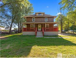 Brownstown house for rent - A house with a red front porch is for sale.