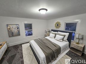 Brownstown house for rent - A bedroom with a large bed, a nightstand, and a painting on the wall.