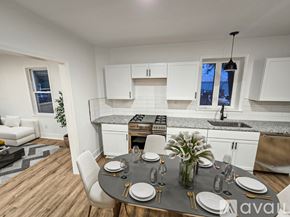 Brownstown house for rent - A modern kitchen with a dining table set for two.