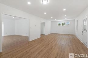 Brownstown house for rent - A spacious room with wooden flooring and white walls.