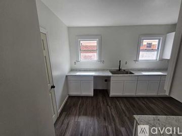 Detroit house for rent - A kitchen with a sink and a window.