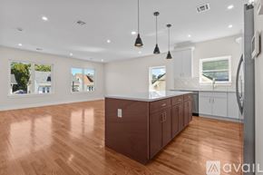 Newark apartment for rent - A kitchen with brown cabinets and a wooden floor.
