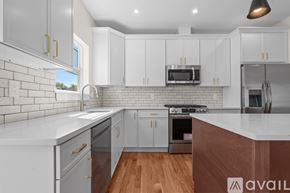Newark apartment for rent - A kitchen with white cabinets and a wooden floor.
