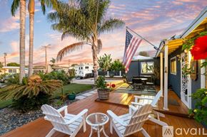 San Diego house for rent - A wooden deck with two chairs and an American flag.