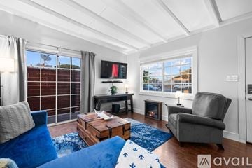San Diego house for rent - A living room with a blue couch and a television.