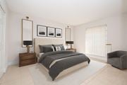 Kendall apartment for rent - a bedroom with white walls and a large window and a bed