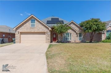 Abilene house for rent - A house with a garage and a driveway in front.