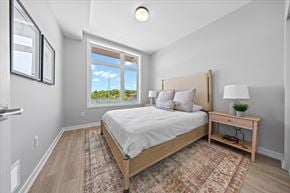 Ottawa apartment for rent - A bedroom with a large bed and a window overlooking the outdoors.