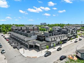 Ottawa apartment for rent - A parking lot with cars and a building in the background.