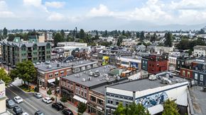 Chilliwack apartment for rent - A city street with cars and buildings.