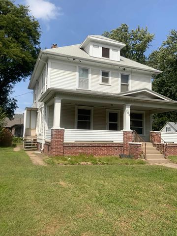 Fremont apartment for rent - A white house with a porch and a covered staircase.