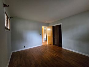 Michigan City house for rent - A room with wooden floors and a door.