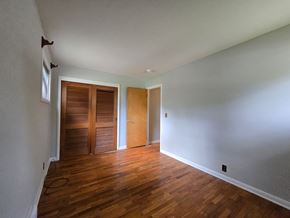 Michigan City house for rent - A room with wooden floors and white walls.