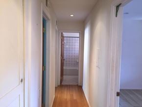 Santa Barbara house for rent - A long hallway with a door at the end.
