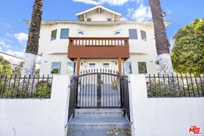 Los Angeles apartment for rent - A white house with a black gate in front.