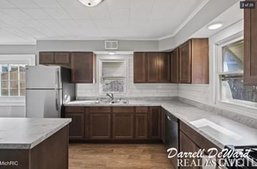 Grand Rapids house for rent - A kitchen with brown cabinets and a marble countertop.