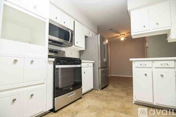 Columbus house for rent - A kitchen with white cabinets and appliances.