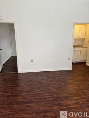 Cambridge Springs apartment for rent - A room with wooden floors and white walls.
