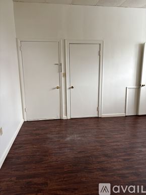 Cambridge Springs apartment for rent - Three white doors in a room with wooden floors.