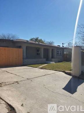 San Antonio apartment for rent - A house with a brown fence and a grey roof is shown.