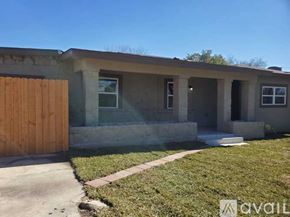 San Antonio apartment for rent - A house with a brown door and a concrete wall.