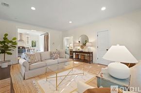 Savannah house for rent - A well-lit living room with a grey sofa, a coffee table, and a large floor lamp.