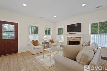 Savannah house for rent - A living room with a white couch and a fireplace.