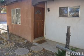 Santa Fe apartment for rent - A brown door is on the side of a house.