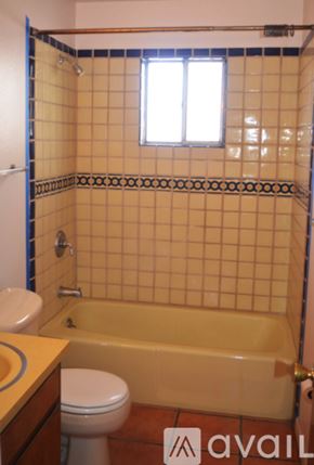 Santa Fe apartment for rent - A bathroom with a toilet, tub, and tiled walls.