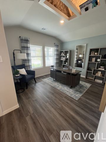 Lavon house for rent - A living room with a blue chair and a wooden floor.