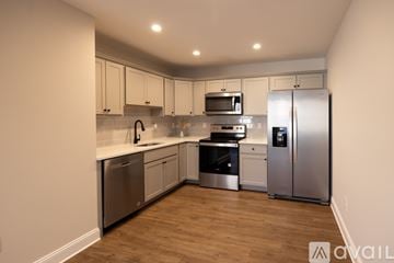 Stroudsburg apartment for rent - A kitchen with stainless steel appliances and wooden floors.