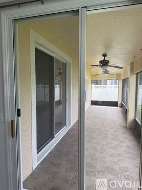 Kissimmee house for rent - A small refrigerator is installed in a narrow space between a door and a wall.
