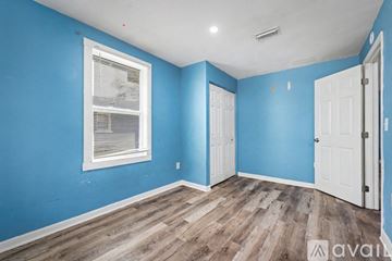 Jacksonville house for rent - A kitchen with blue walls and wooden floors.