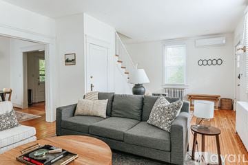 Charlottesville house for rent - A living room with a grey couch and a coffee table.