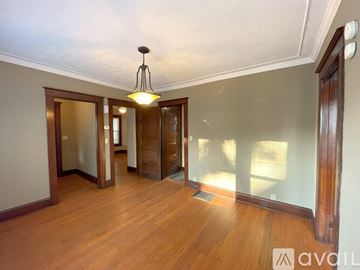 Elmira apartment for rent - A kitchen with wooden cabinets and a white refrigerator.