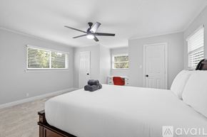 Flower Mound house for rent - A bedroom with a large bed and a ceiling fan.